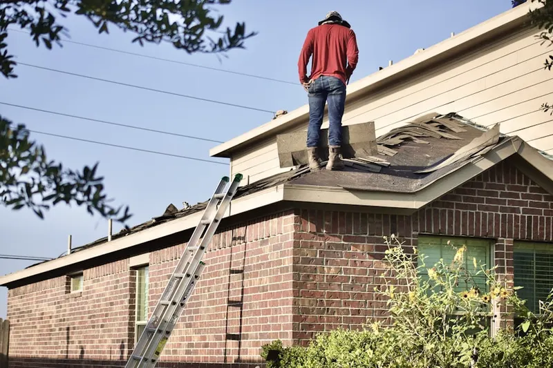Professional roofer working on a residential roof in Uptown Whittier